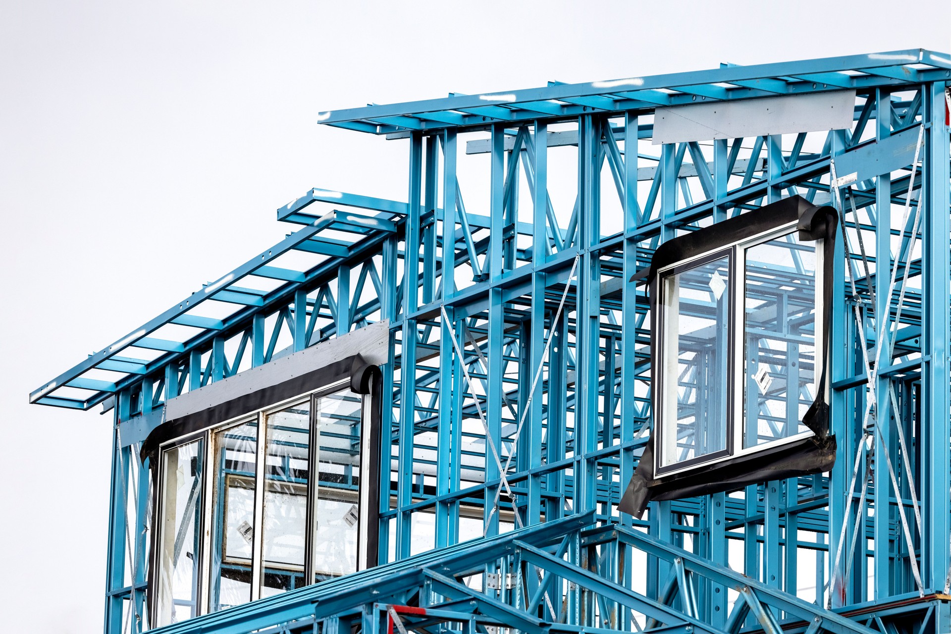 Construction site of house steel frame, closeup, copy space