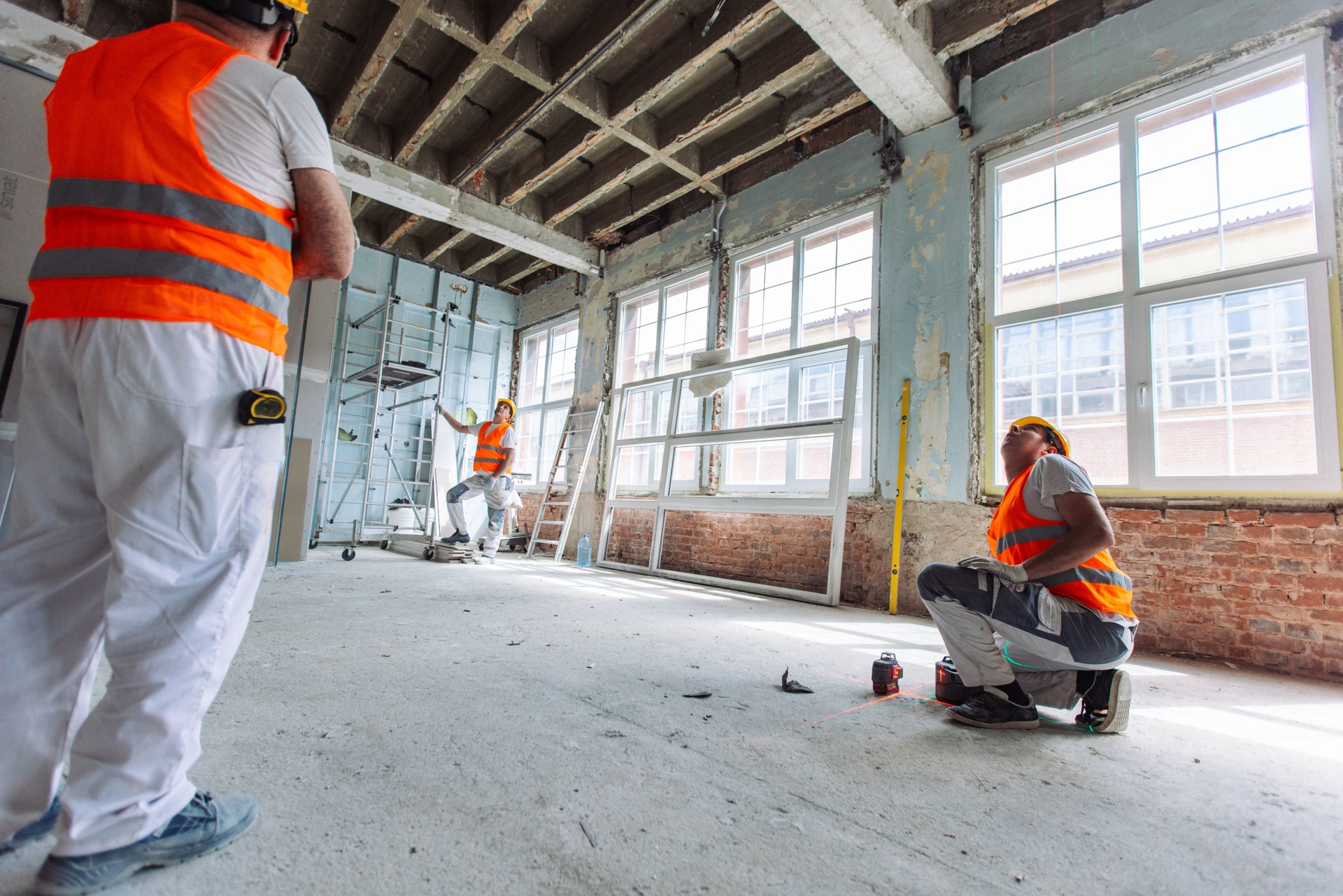 Planning and measuring by workers in a renovation site